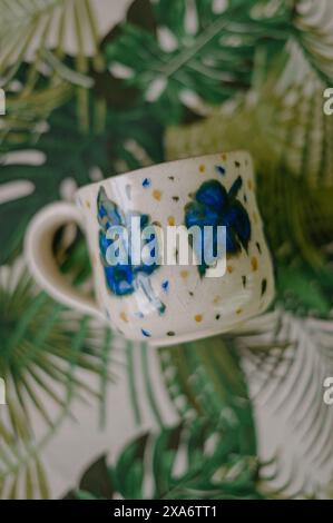 The beautiful hand-made ceramic mug displayed on the table Stock Photo