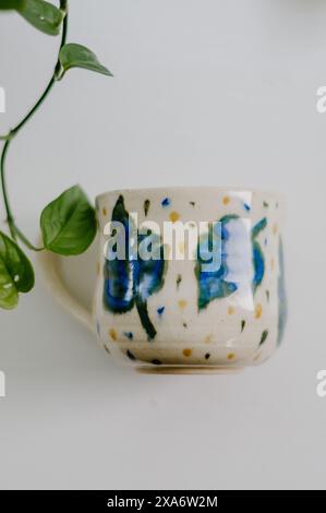 The beautiful hand-made ceramic mug displayed on the table Stock Photo