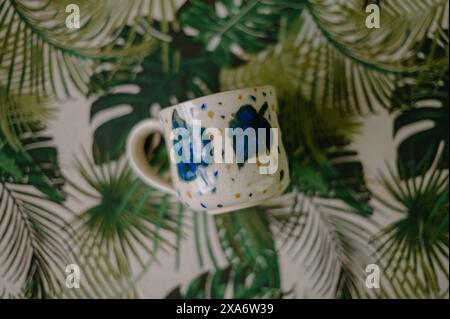The beautiful hand-made ceramic mug displayed on the table Stock Photo