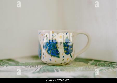 The beautiful hand-made ceramic mug displayed on the table Stock Photo