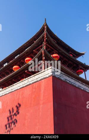 A red building with numerous windows in China Stock Photo