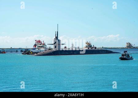 May 29, 2024 - Apra Harbor, Guam - The Ohio-class ballistic missile submarine USS Louisiana (SSBN 743) (Gold Crew) arrives at Naval Base Guam, May 29 to conduct a scheduled port visit. This port visit reflects the strategic importance of Guam and the USA' commitment to a free and open Indo-Pacific region. The visit further enhances significant partnerships shared between DoD, the government of Guam and the island community. The presence of the SSBN in Guam demonstrates the flexibility, survivability, readiness, and capability of the U.S. Navy submarine forces and complements the many exercises Stock Photo