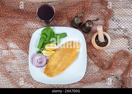 Fried salmon with corn tortillas flavored with cornmeal. Pieces of fried fish coated in cornmeal. Salmon fillet cooked in cornmeal. Stock Photo