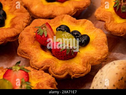 Assorted fruit tarts on a table setting Stock Photo