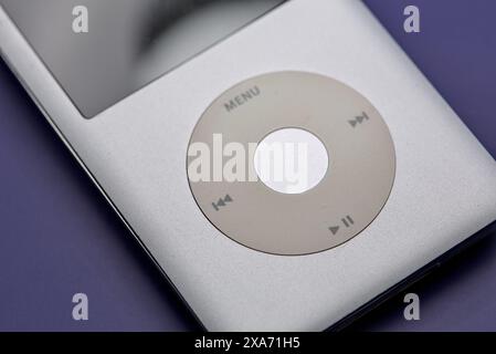Apple Ipod classic portable mp3 player on a blue white magenta background. Stock Photo