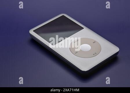 Apple Ipod classic portable mp3 player on a blue white magenta background. Stock Photo