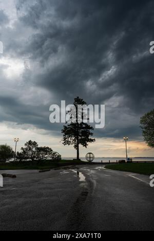 The Dramatic clouds rolling over sunset at Couchiching Beach Park Stock Photo