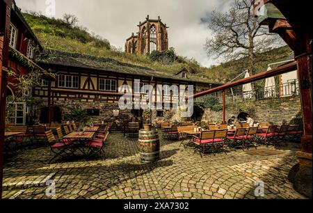 View into the courtyard of the Old Post Office in Bacharach, in the background the ruins of the Werner Chapel, Upper Middle Rhine Valley, Rhineland-Pa Stock Photo