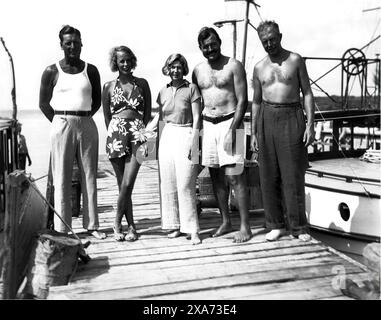 Ernest Hemingway and fishing friends on the dock in Key West, FL. Stock Photo