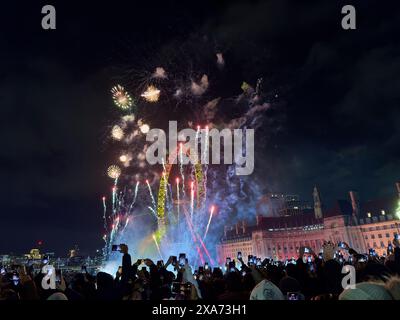 Fireworks illuminate the sky against city skyline Stock Photo