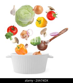 Fresh ingredients falling into saucepan on white background Stock Photo
