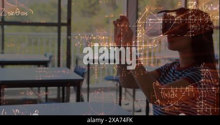 Image of mathematical formulas over biracial female student using vr headset Stock Photo