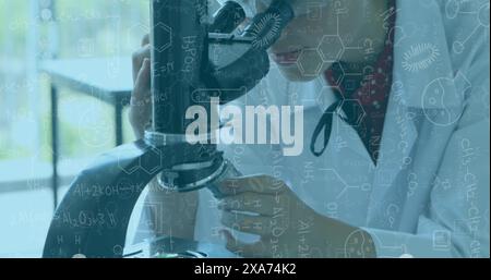Image of scientific formulas over female scientist using microscope Stock Photo