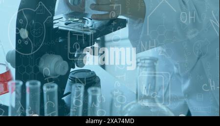 Image of scientific formulas over female scientist using microscope Stock Photo