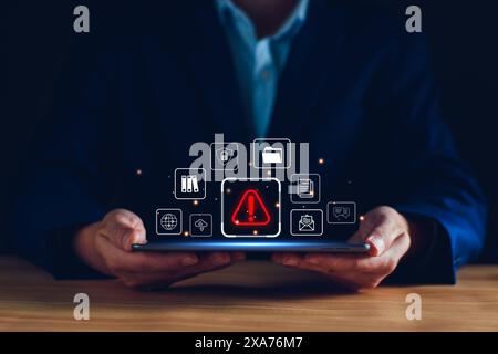 Businessman staff, programmer, developer using technology with triangle caution warning sign notification error and maintenance concept. System warnin Stock Photo