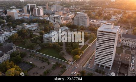 Jackson, Mississippi, USA - April 23, 2024: Sunset light shines on the historic Capitol and  buildings of downtown Jackson skyline. Stock Photo