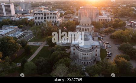 Jackson, Mississippi, USA - April 23, 2024: Sunset light shines on the historic Capitol and  buildings of downtown Jackson skyline. Stock Photo