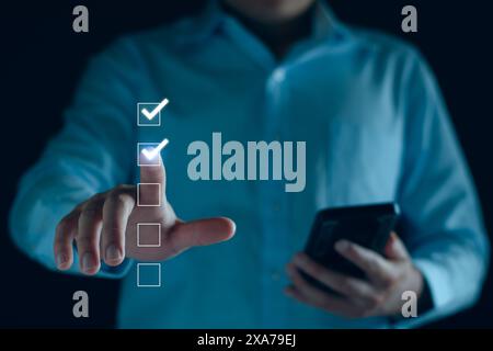 Check list, Businessman Take an assessment, questionnaire, evaluation, online survey exam Choosing the right answer in the exam, filling out an online Stock Photo