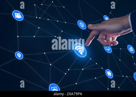 Smart business IOT, internet of things concept. Businessman touching IOT icon on virtual screen, connected internet network to access AI intelligence, Stock Photo