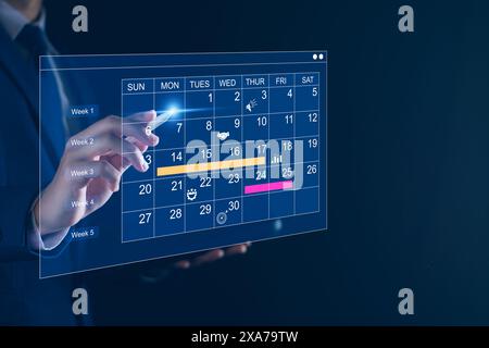 Work planning and business project management concept, virtual calendar screen and updating tasks and milestones progress planning to improve time man Stock Photo