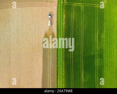 Top down view of a tractor fertilizing the fieldin germany Stock Photo