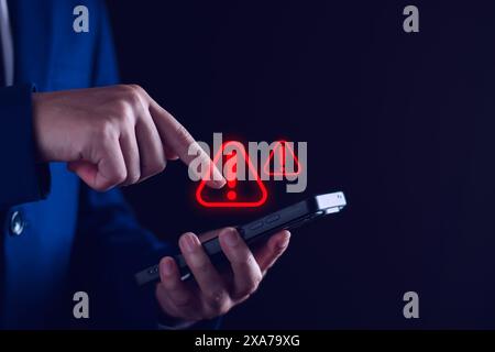 Businessman staff, programmer, developer using technology with triangle caution warning sign notification error and maintenance concept. System warnin Stock Photo