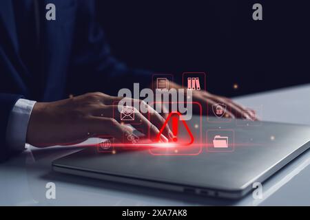 System warning hacked alert, cyber attack on computer network. programmer, Businessman staff, developer using technology with triangle caution warning Stock Photo