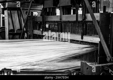 The cotton thread lines on a copwinder weft assembly line loom in Johannesburg, South Africa Stock Photo