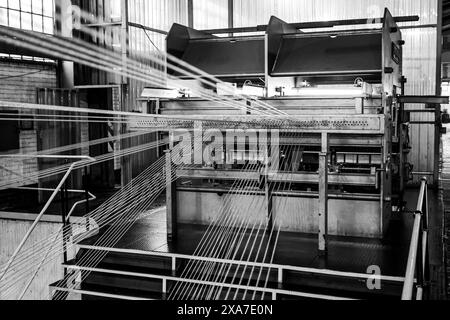 The spools of cable on a conveyor belt machine in a factory in Johannesburg, South Africa Stock Photo