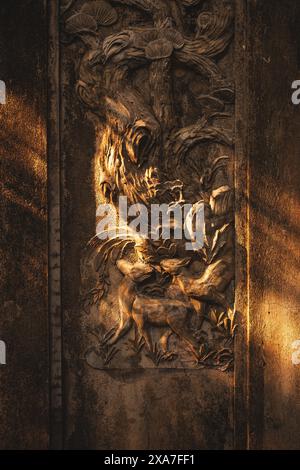 A wooden panel featuring intricate dragon and boar design Stock Photo