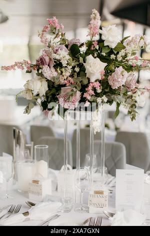 A close-up of an elegant table setting with vase and silverware Stock Photo