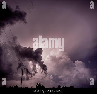 A dramatic lightning bolt strikes over a stormy landscape Stock Photo
