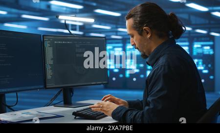 System administrator working in high tech server room capable of storing vast amounts of data, using computer. IT engineer typing on PC keyboard, upgrading servers controlling network resources Stock Photo