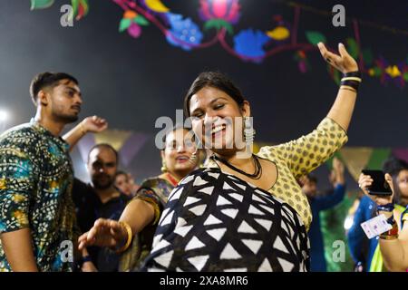 Baroda, India - 17th October 2023: Indian people in traditional sari and kurta dresses dance the Garba music during the hindu Navratri festival to hon Stock Photo