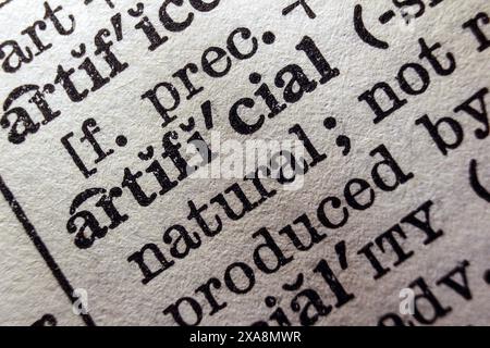 Word artificial on dictionary page, macro close-up Stock Photo