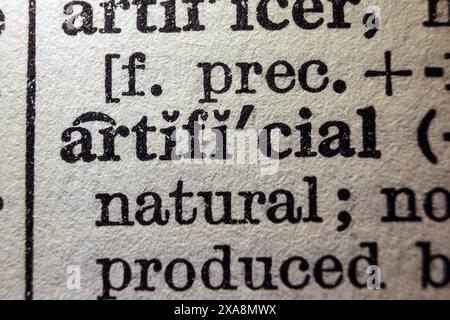 Word artificial on dictionary page, macro close-up Stock Photo