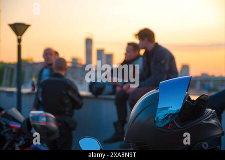 Motorbike helmet against defocused riders Stock Photo