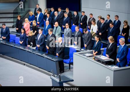 05 June 2024, Berlin: Bundestag President Bärbel Bas (SPD, 2nd from right), together with Federal Chancellor Olaf Scholz (SPD, bottom left) and the entire government bench in the plenary session of the German Bundestag, commemorates the policeman who died in an attack in Mannheim. The agenda of the 171st session of the 20th legislative period includes a government inquiry with the Minister of Defense and the Head of the Chancellery as well as debates on the Bundeswehr missions in Bosnia-Herzegovina (Eufor Althea) and Kosovo (KFOR) and the abolition of the solidarity surcharge. Photo: Christoph Stock Photo
