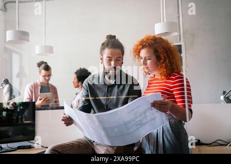 Young business people, engineers, managers working with new startup project in modern office Stock Photo