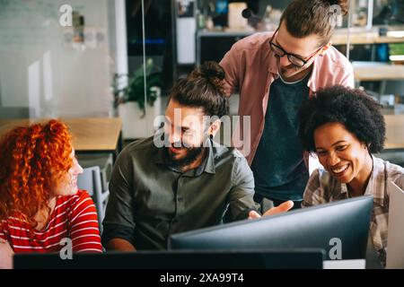 Mixed team of software engineers brainstorming ideas. Diverse app developers collaborating as group Stock Photo