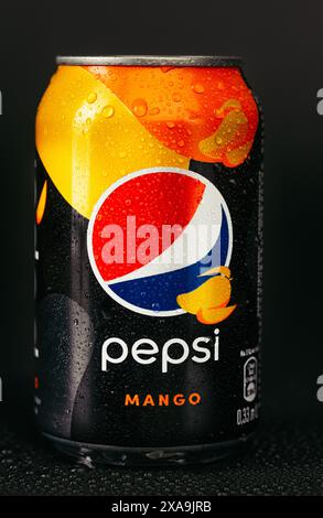 Kyiv, Ukraine - February 26, 2020. Pepsi mango on a black background with drops of water. Stock Photo