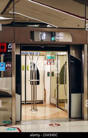 Doha, Qatar - 1 May 2024: Train at a metro station in Doha, open door to a family type carriage Stock Photo