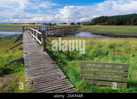 Aberlady Local Nature Reserve showing entrance via wooden footbridge over the Peffer Burn at low tide, Firth of Forth, East Lothian, Scotland. Stock Photo