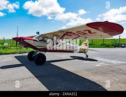 View of a 1958, Piper PA-18-150 Super Cub C/N 18-6754, taxiing in , after landing, during the Kent Strut charity fly-in to Manston, Kent Stock Photo