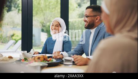 Islamic, family and dinner in home for eid, muslim celebration and serving food on dining table. Ramadan, culture and religious gathering with Stock Photo