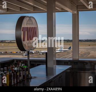 A rooftop bar at the TWA Hotel at JFK Airport in New York City with planes in the background. Stock Photo