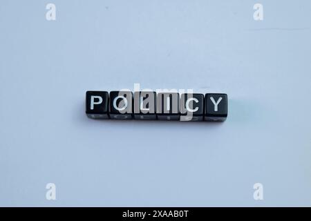 Concept of The wooden Cubes with the word Policy on wooden background. Stock Photo