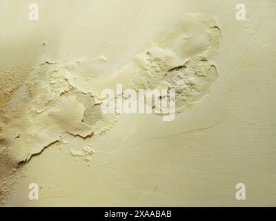 A dirty and cracked drywall on a wall Stock Photo