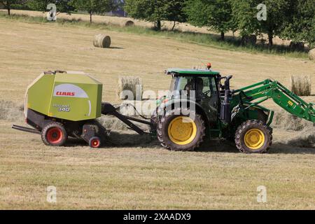 Limousin, France. June 5, 2024. Haymaking in Limousin. After the long spring rains, it is time to harvest hay in the southwest of France. This hay harvested by Limousin farmers will be used during the winter to feed Limousin beef cows. Agriculture, farmers, cattle breeders, cattle breeding, agricultural work, food. Limousin, Nouvelle Aquitaine, France. Europe. Credit: Photo by Hugo Martin/Alamy Live News. Stock Photo