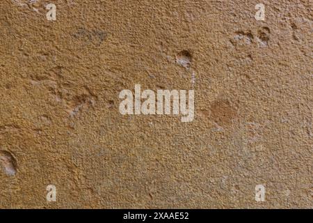 close-up flat photography of an ancient stone wall texture in light terracotta colour Stock Photo